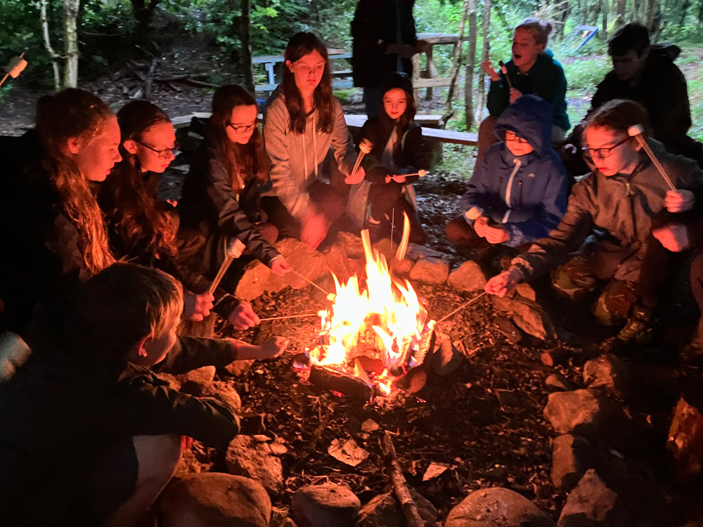 Campers toasted marshmallows at the camp fire. Faye Vogely